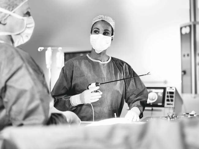 A doctor holds the TriSect Rapide in an operation theater looking to a nurse.